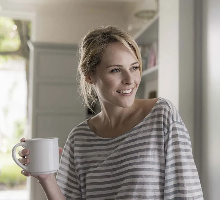 Woman with mug smiling